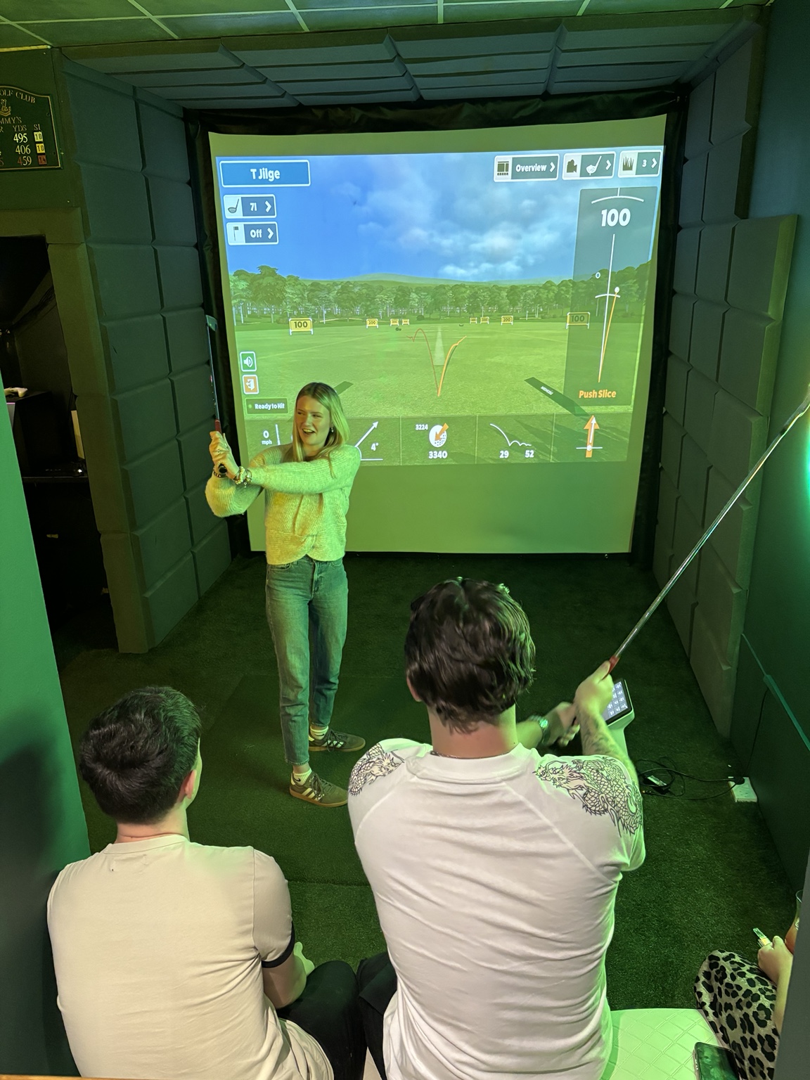 Friends enjoying the Fairways golf simulator